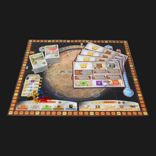 A board game set displayed, featuring a dark space-themed playmat with colorful orbital rings, cards, tokens, and small game pieces.