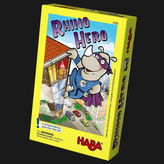A boxed board game titled "Rhino Hero" by HABA, shown at a slight angle against a plain white background. The box is bright yellow with colorful cartoon artwork of a rhinoceros superhero climbing a building, plus the HABA logo in red at the bottom.