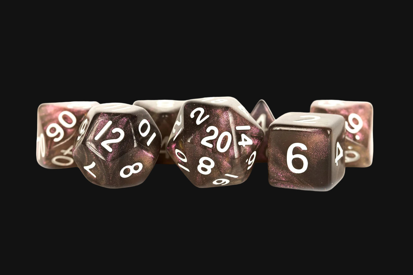 Set of polyhedral dice with metallic sheen on a black background