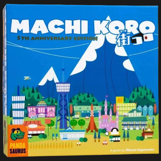 Front of the Machi Koro 5th Anniversary Edition board game box by Panda Saurus, featuring a colorful illustrated cityscape with mountains, buildings, and the title in large white letters on a bright blue background.